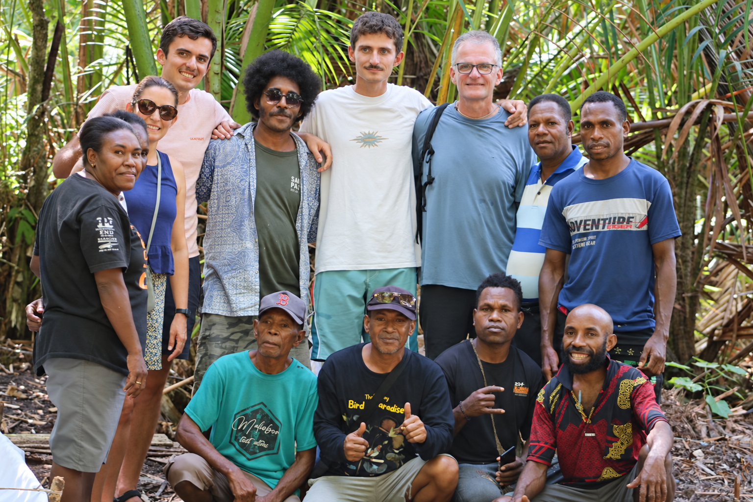 Amid the sago groves, participants from Nanggouw, Saupon managers, representatives from the Department of Tourism, and tourists pose for a photo after the planting activity. The visit will come to an end, but the sago plants will take time to grow. That is where the significance of this activity lies: leaving behind something that can be cared for and will eventually benefit village life.